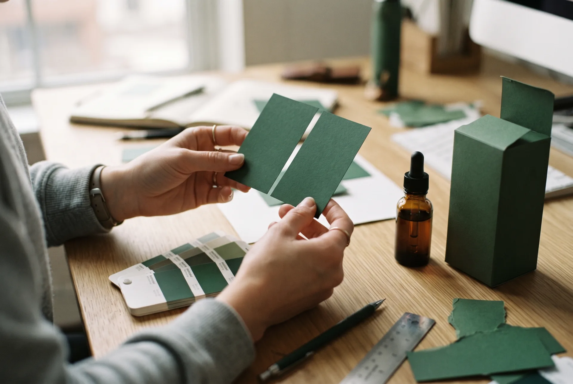 Designer comparing green label proofs
